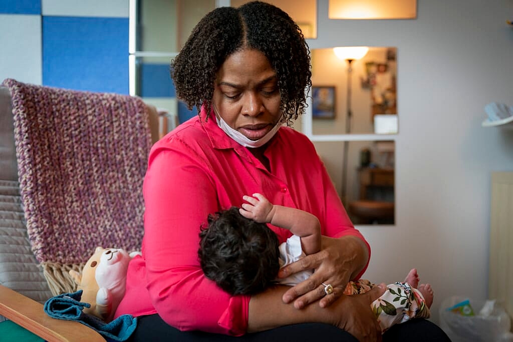 Capri Isidoro looks at her one-month-old baby Charlotte during a lactation consultation