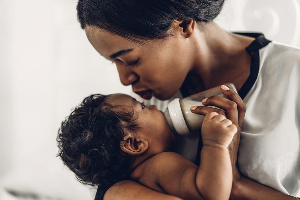 Woman feeding a bottle to a baby