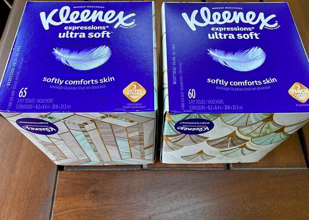 Two nearly identical boxes of Kleenex tissue are shown, one with 65 sheets and the other with 60