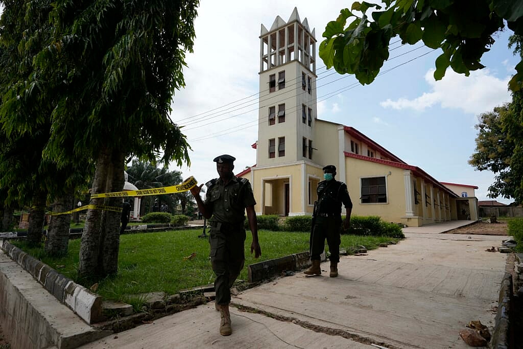 Nigerian police officers tape around the St. Francis Catholic church