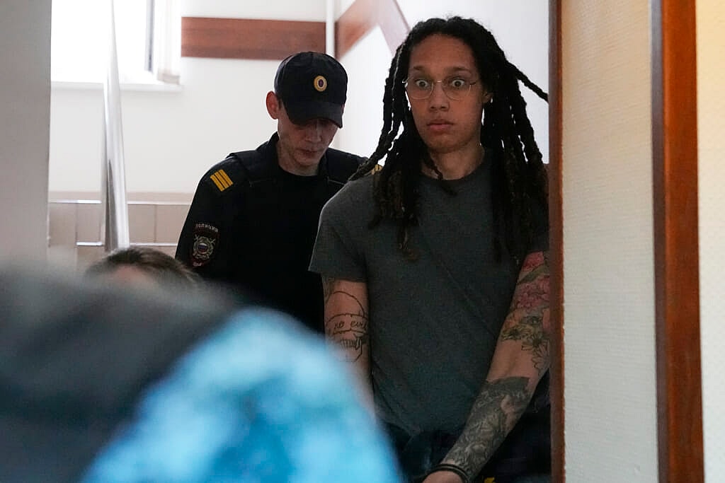 WNBA star and two-time Olympic gold medalist Brittney Griner is escorted to a courtroom