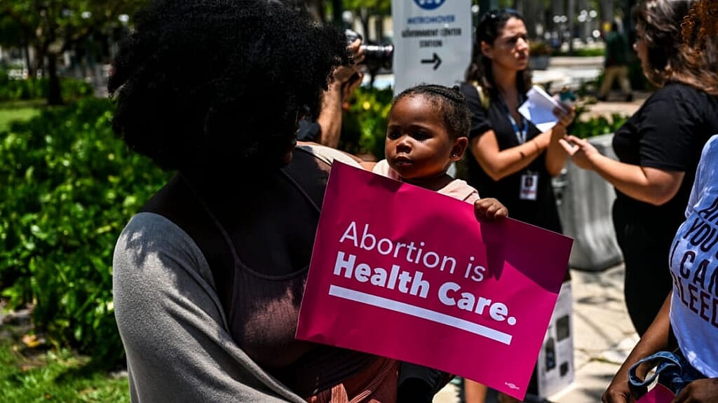 Tifanny Burks holds Novah Smith at an abortion rights protest