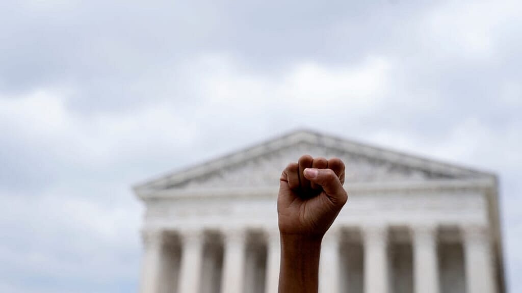 An abortion rights activist raises a fist outside the U.S. Supreme Court