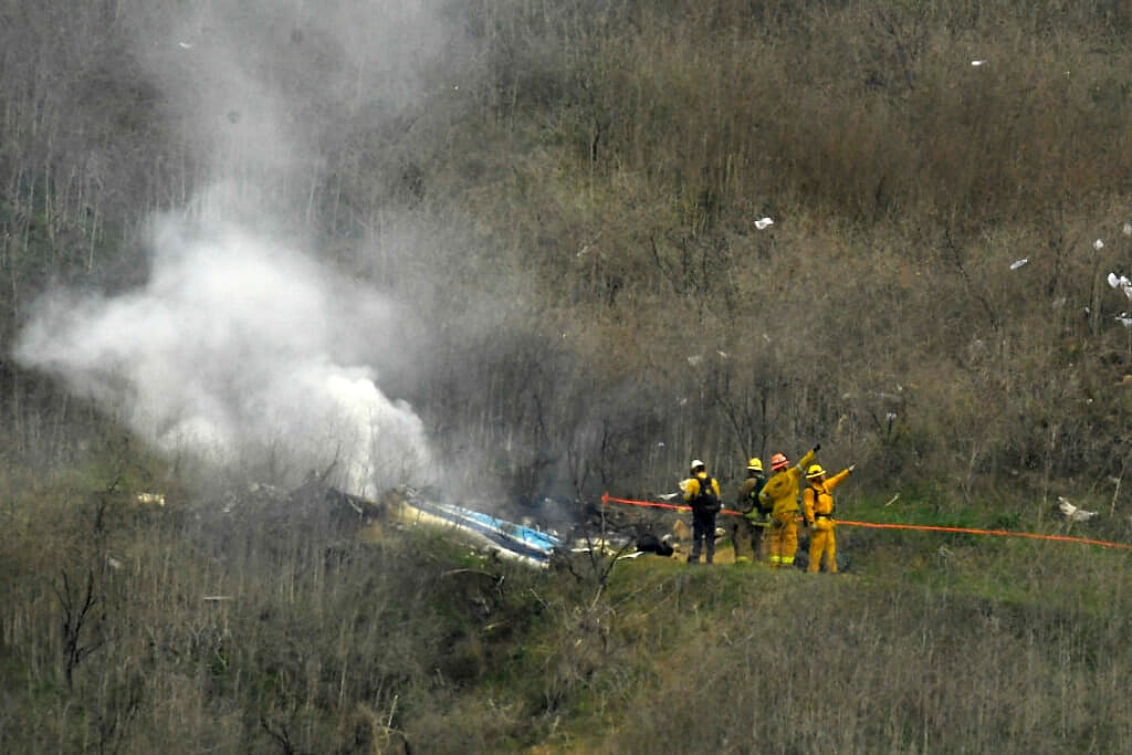 Firefighters work the scene of the Kobe Bryant helicopter crash