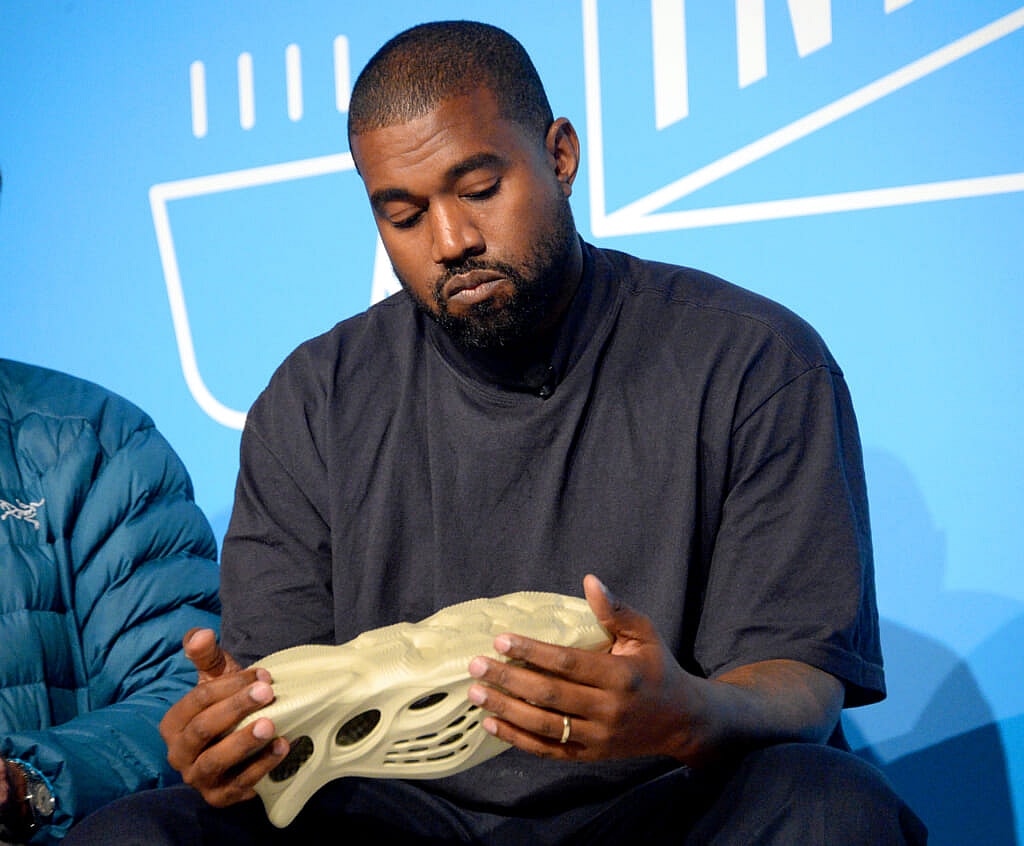 Kanye "Ye" West holding a Yeezy x Adidas design