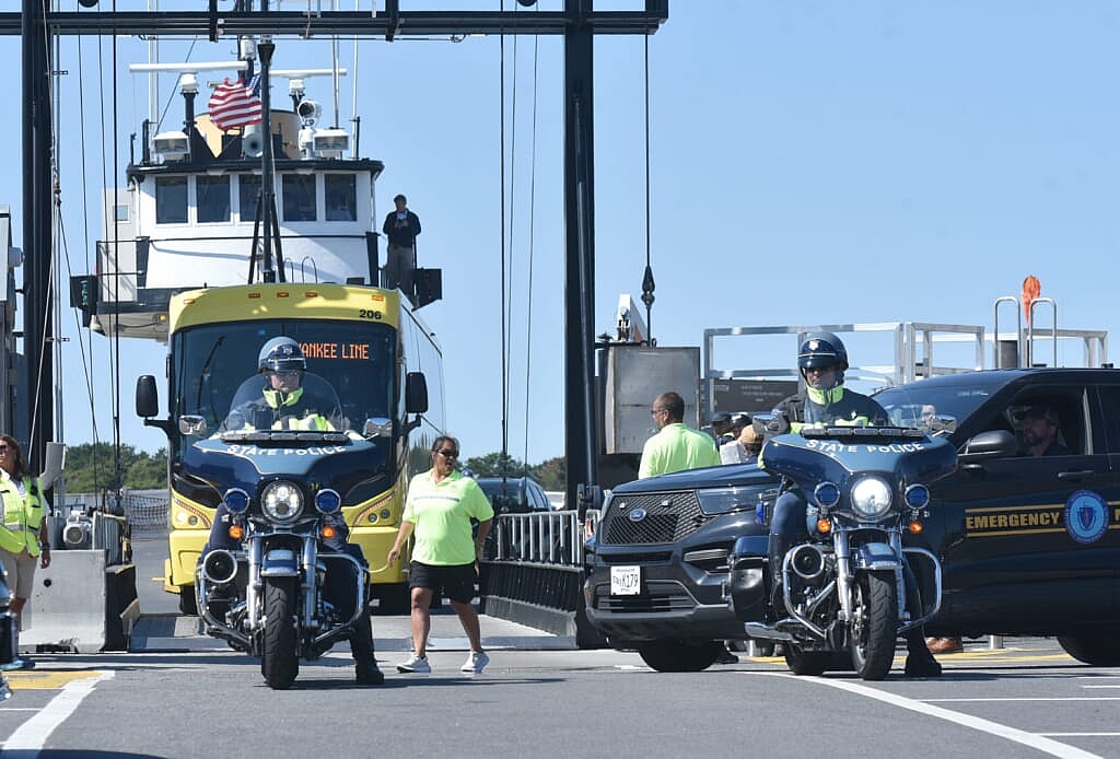 State Police motorcycles lead a motorcade with the bus carrying the Venezuelan migrants