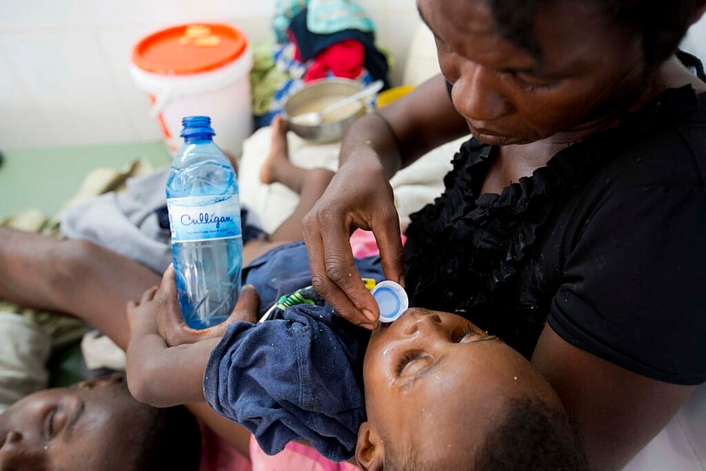 A boy diagnosed with cholera receives treatment