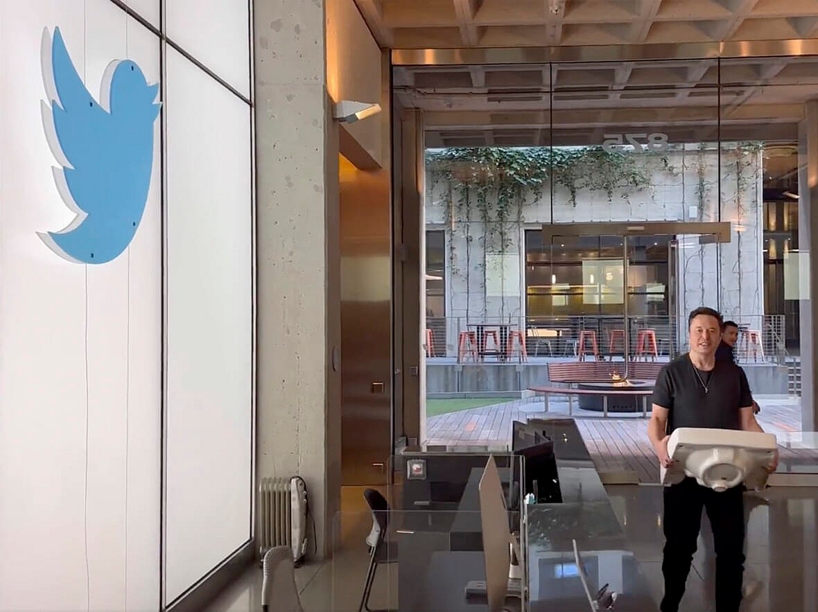 SpaceX CEO Elon Musk carries a sink in the lobby of Twitter Headquarters