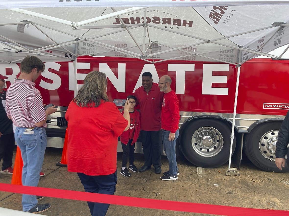 Republican Senate nominee Herschel Walker, a former University of Georgia football star, greets Georgia football fans