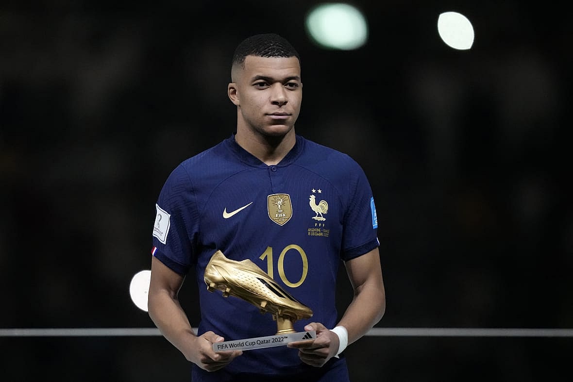 Soccer player Kylian Mbappe of France holds the Golden Boot award