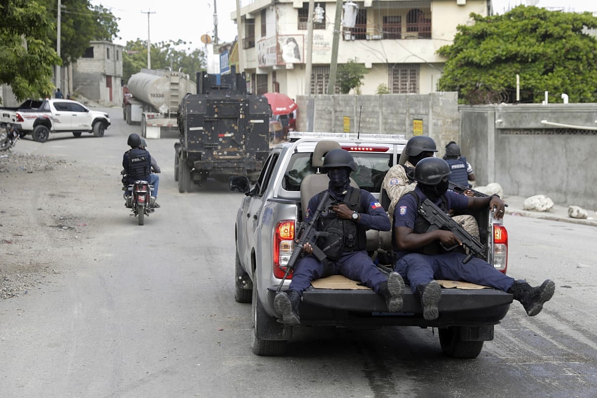 A Haitian police convoy escorts fuel trucks filled with gas