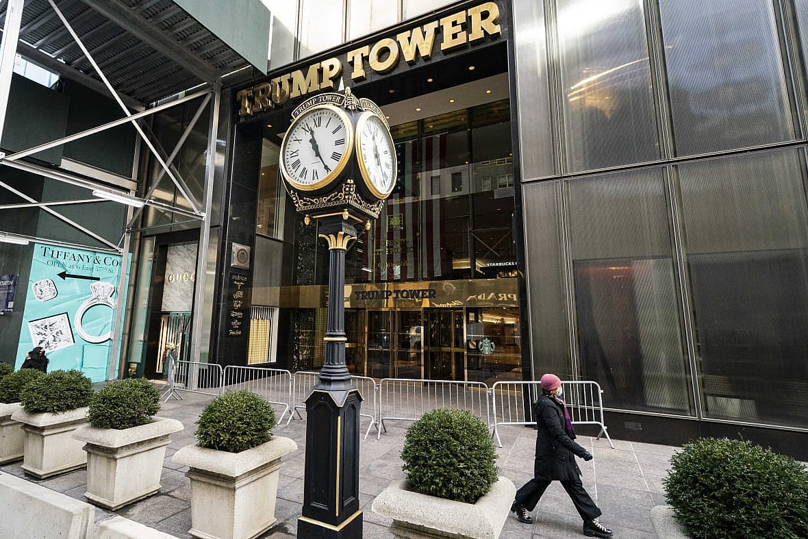 A pedestrian passes security barricades in front of Trump Tower