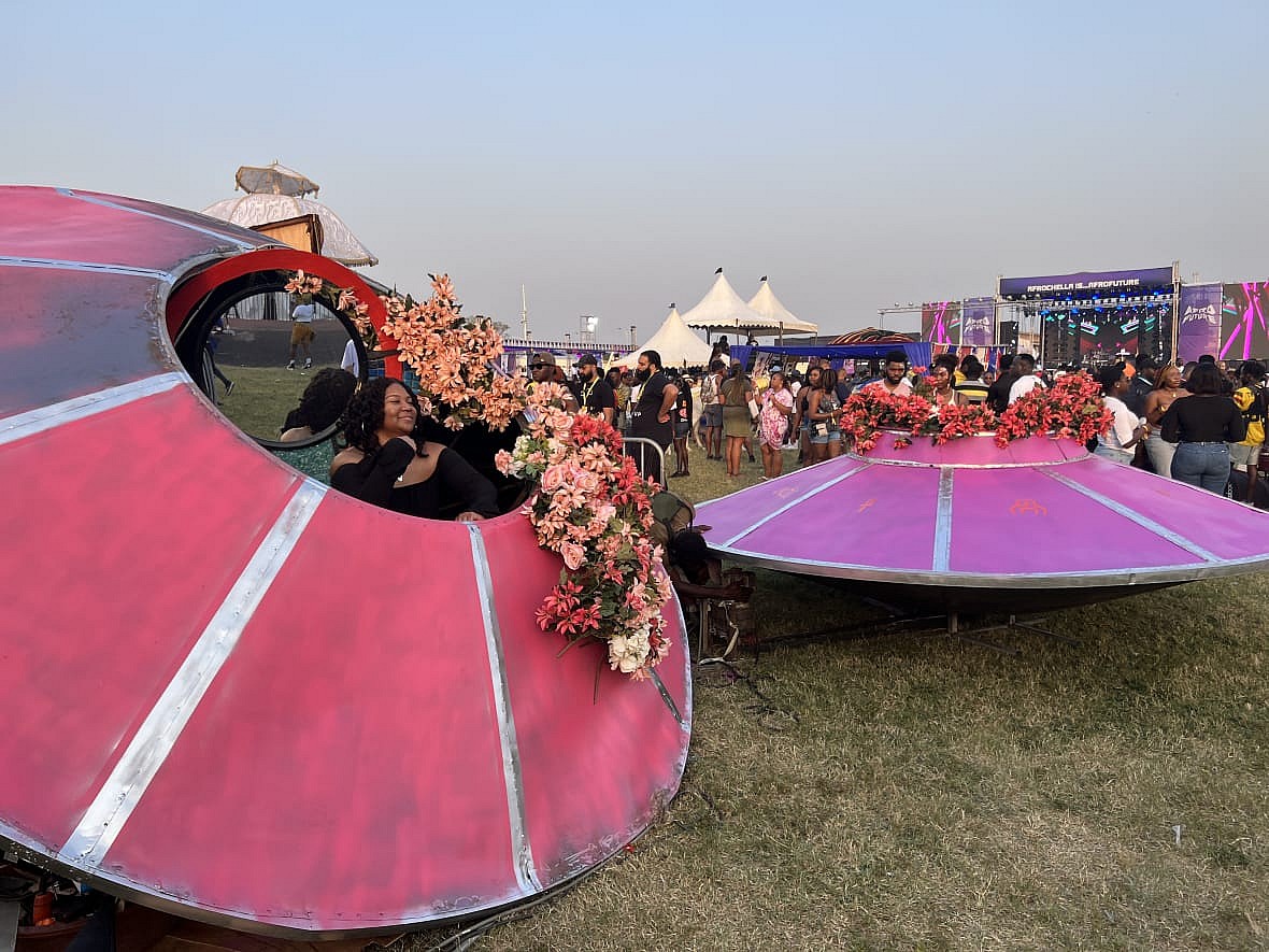 Festival goers interact with a futuristic activation at the 2022 Afrochella Festival