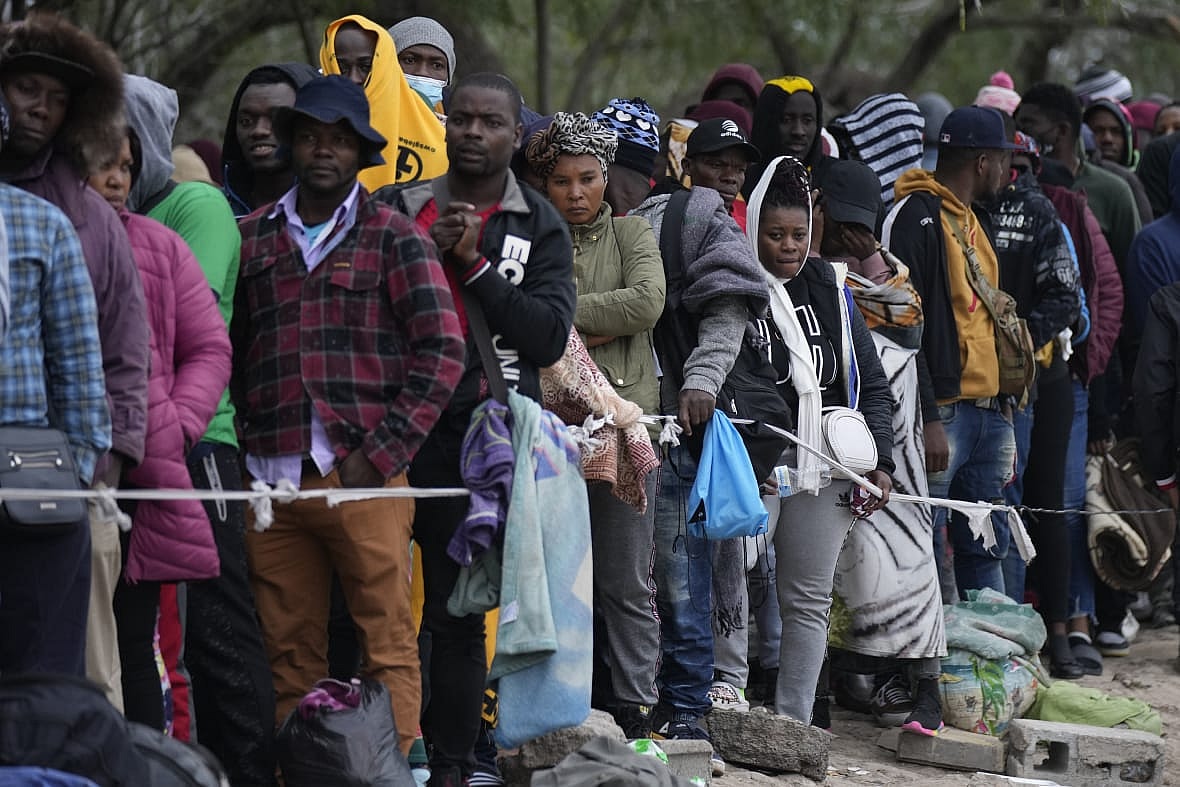 Haitian migrants wait in line