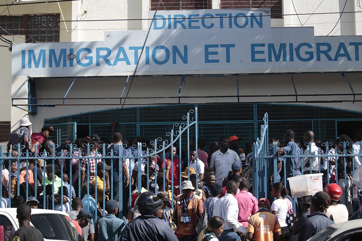 Haitians line up outside an immigration office