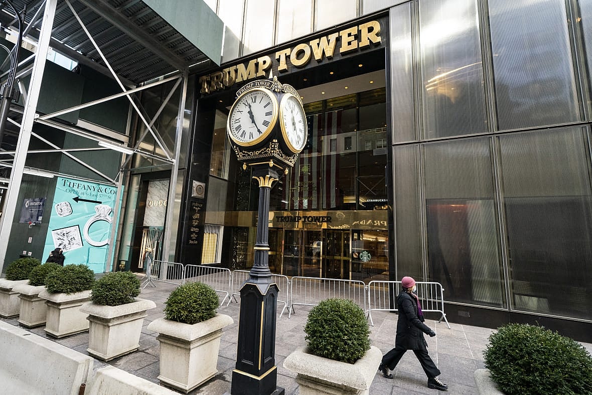 A pedestrian passes security barricades in front of Trump Tower