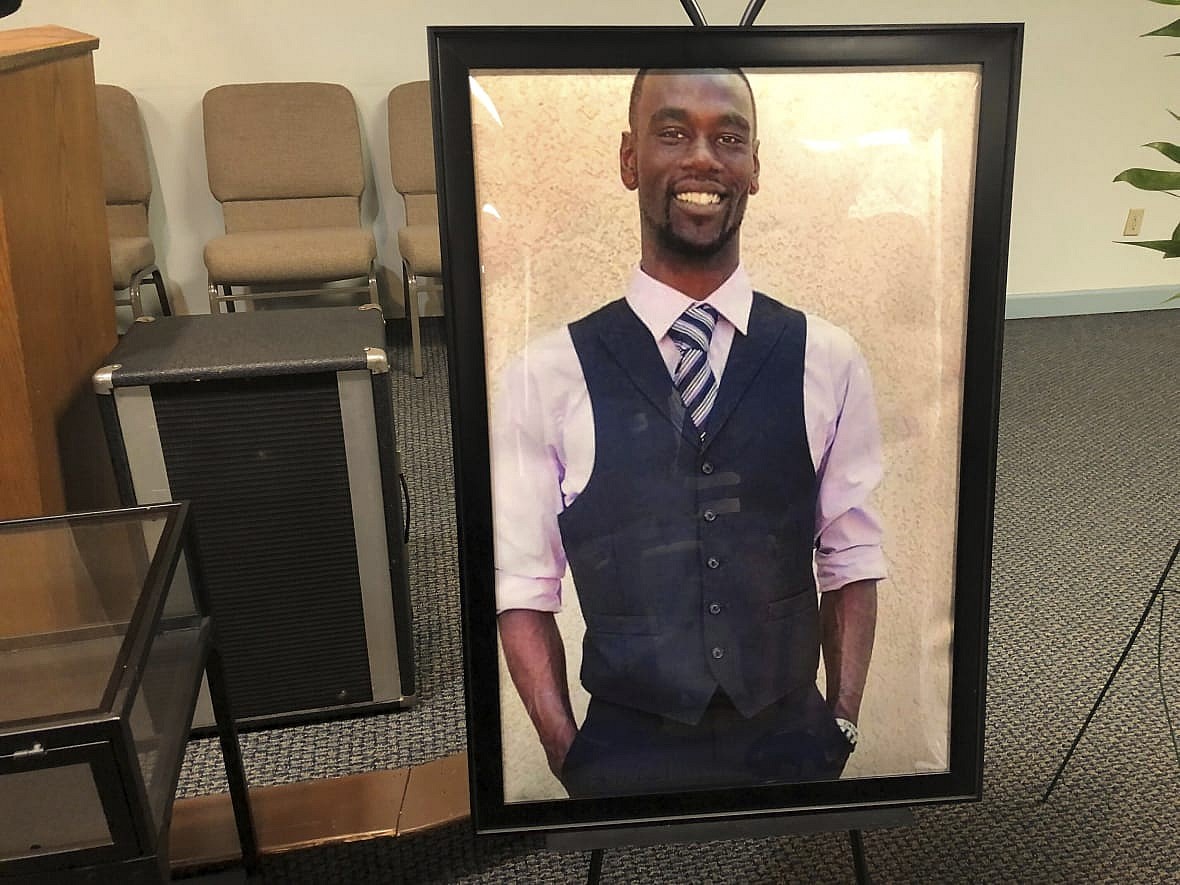 A framed photo of Tyre Nichols at a memorial service