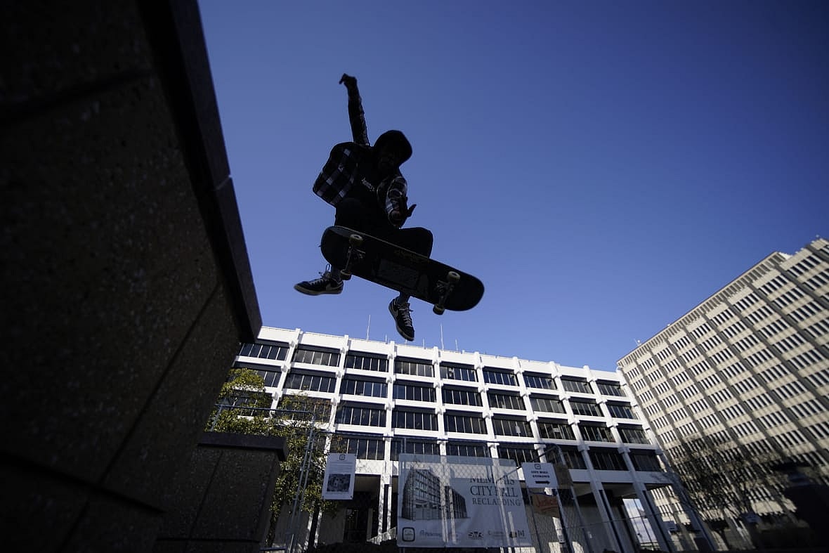 Skateboarder Kam Blakely skates in front of city hall in remembrance of Tyre Nichols