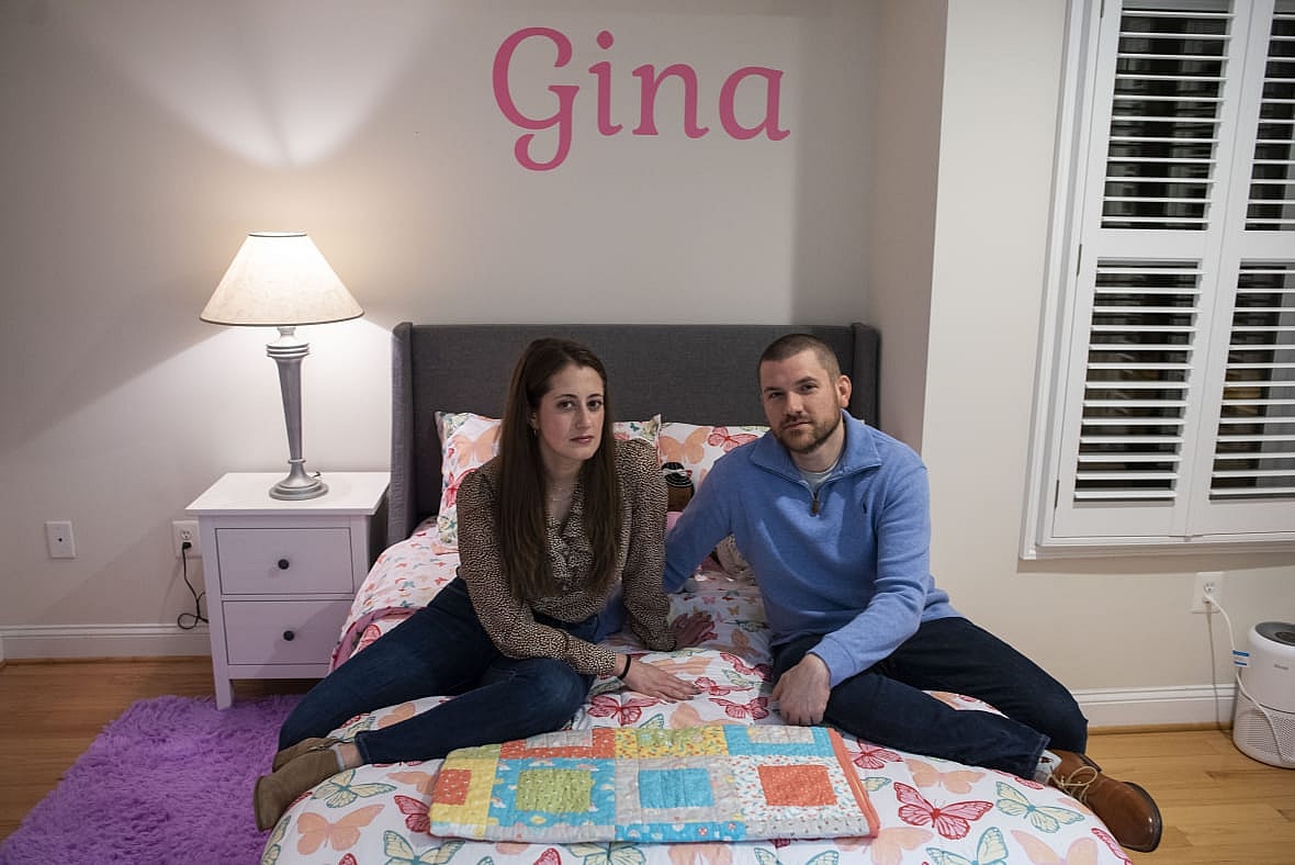 Bryan and Julie Hanlon sit in their adopted daughter’s bedroom