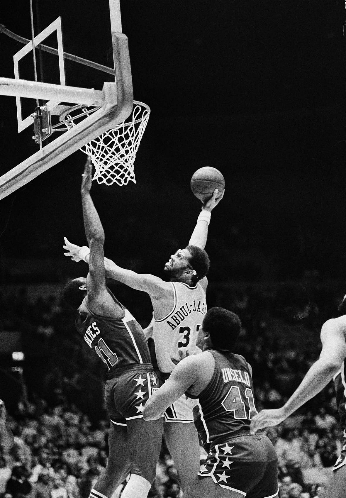 Los Angeles Lakers Kareem Abdul-Jabbar uses his arm to block Washington Bullets Elvin Hayes