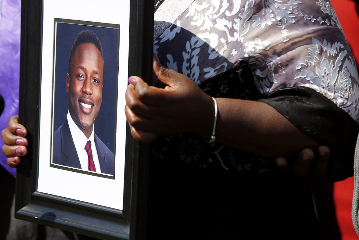Caroline Ouko holds a portrait of her son Irvo Otieno