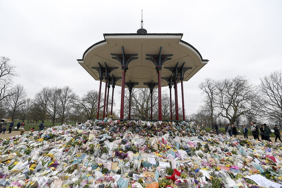 Floral tributes and messages surround the bandstand on Clapham Common in London