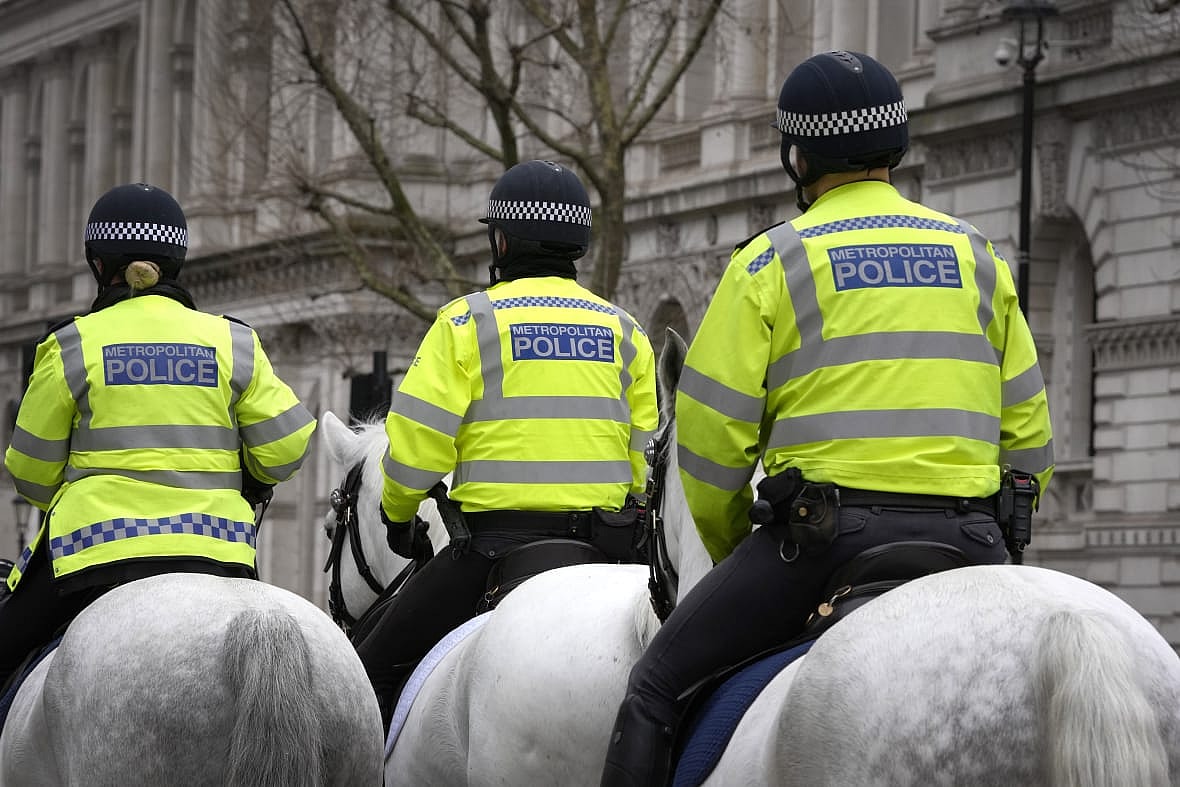 Police officers ride in Westminster in London