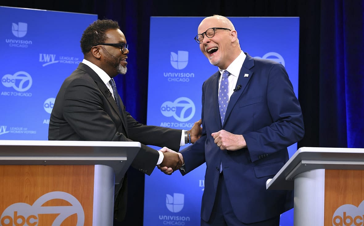 Chicago mayoral candidates Brandon Johnson and Paul Vallas shake hands