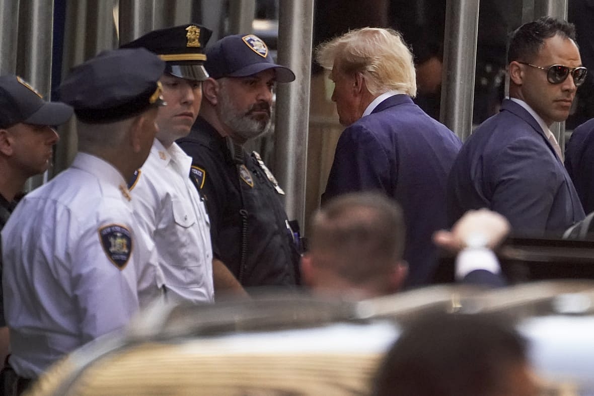Former President Donald Trump, second from right, arrives at the Manhattan District Attorney’s office