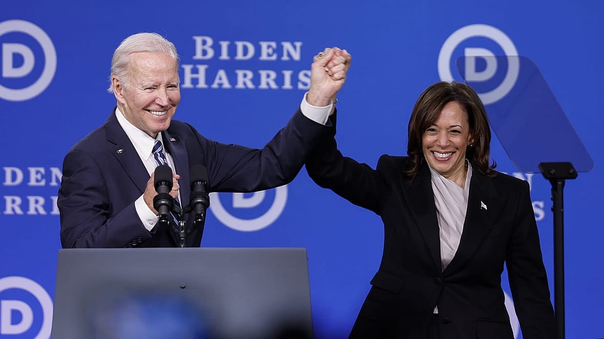 President Joe Biden raises the hand of Vice President Kamala Harris in victory