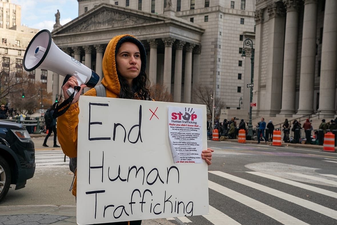 People gather to protest human trafficking at the Thurgood Marshall United States Courthouse