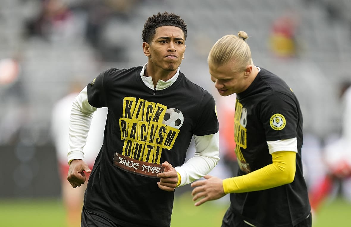 Soccer players Jude Bellingham and Erling Haaland of Dortmund wear t-shirts bearing an anti-racism message