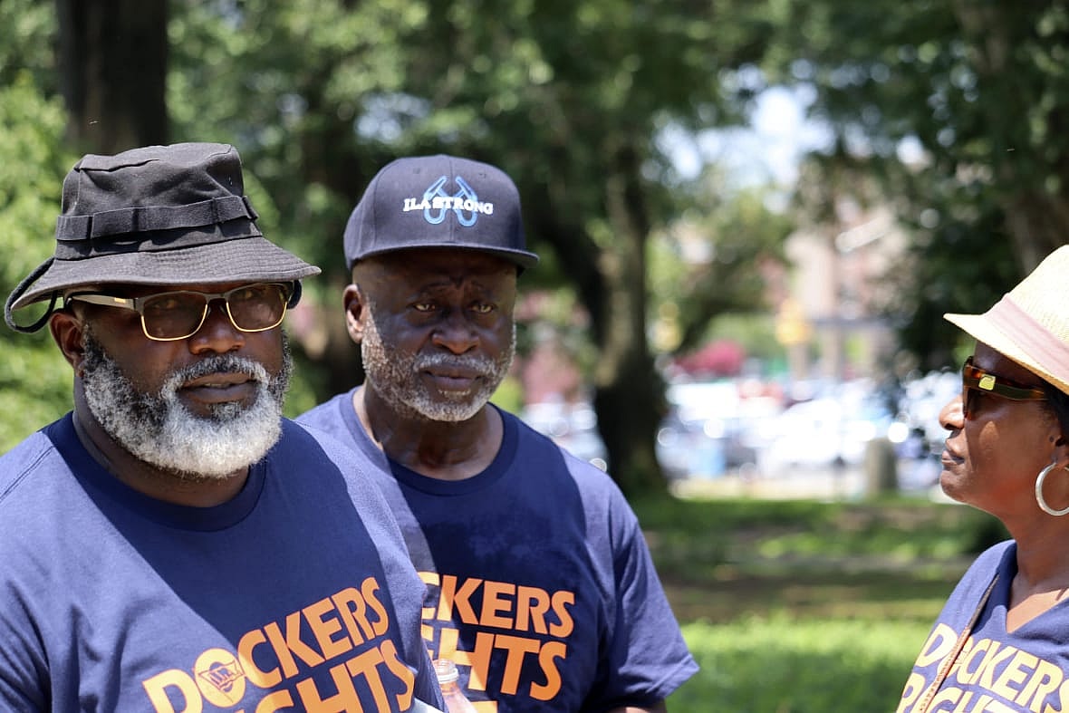 International Longshoremen’s Association International Vice President Ken Riley, center