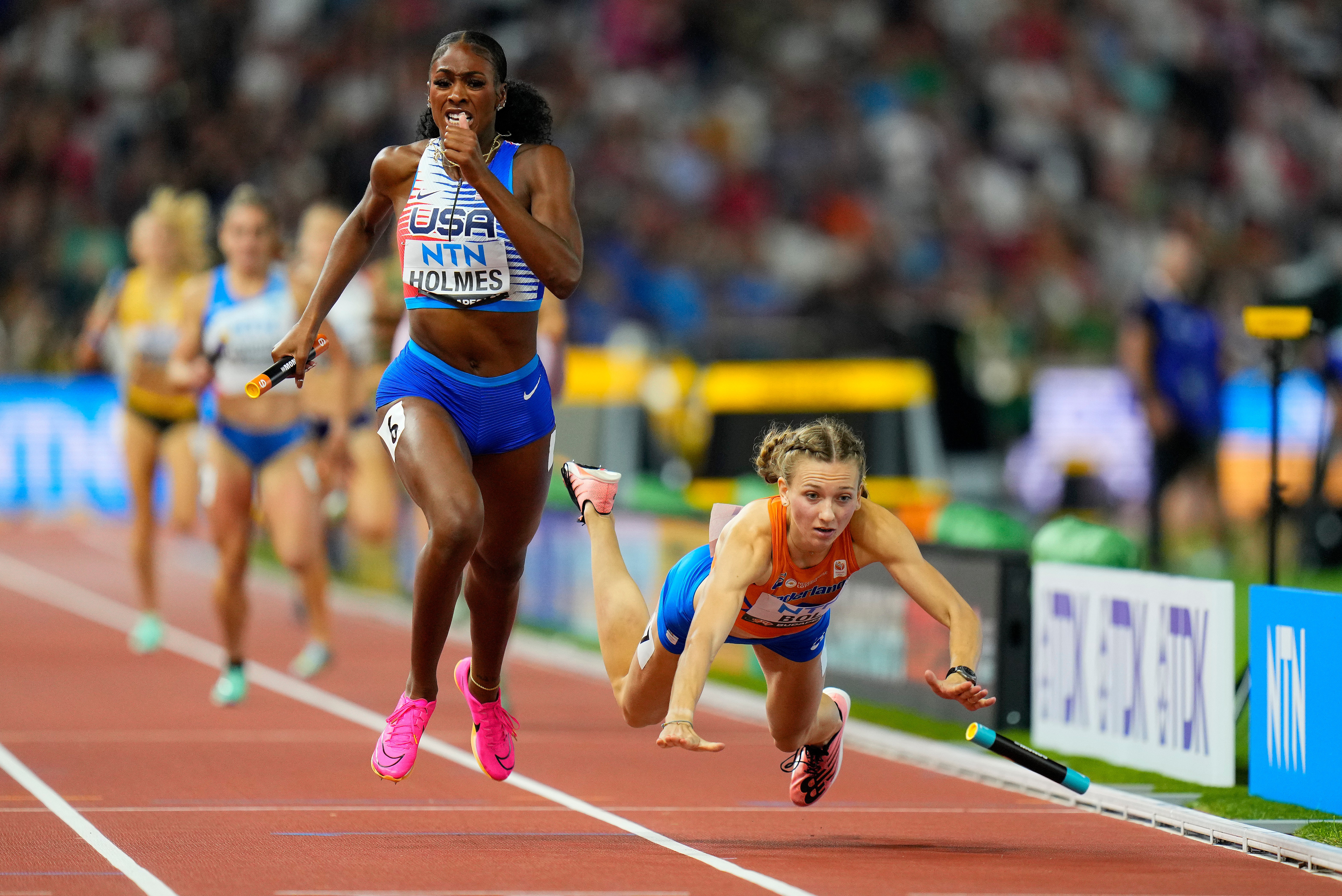 Runners Alexis Holmes of the United States and Femke Bol of the Netherlands