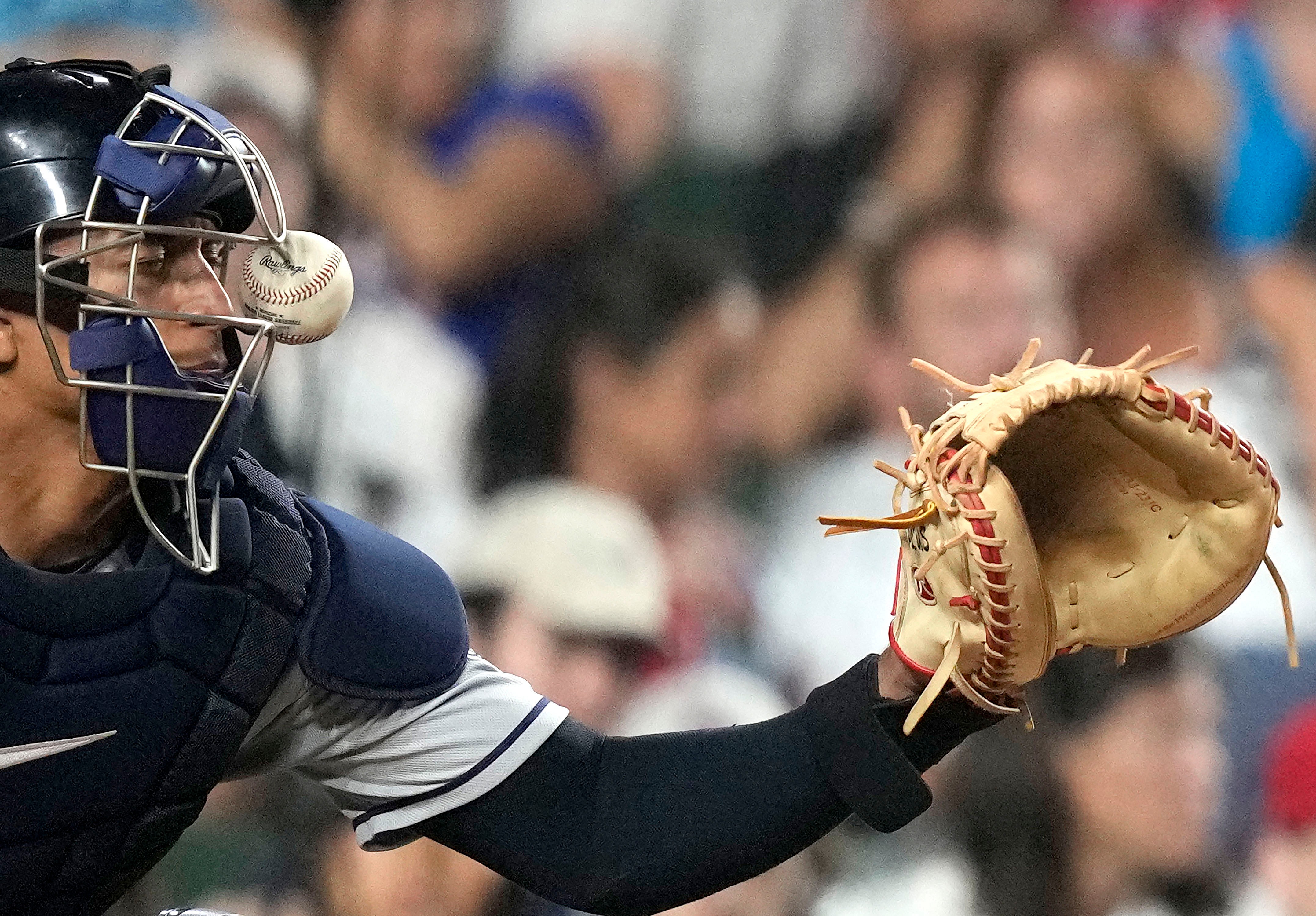 Cleveland Guardians catcher Bo Naylor is hit on the mask by a ball