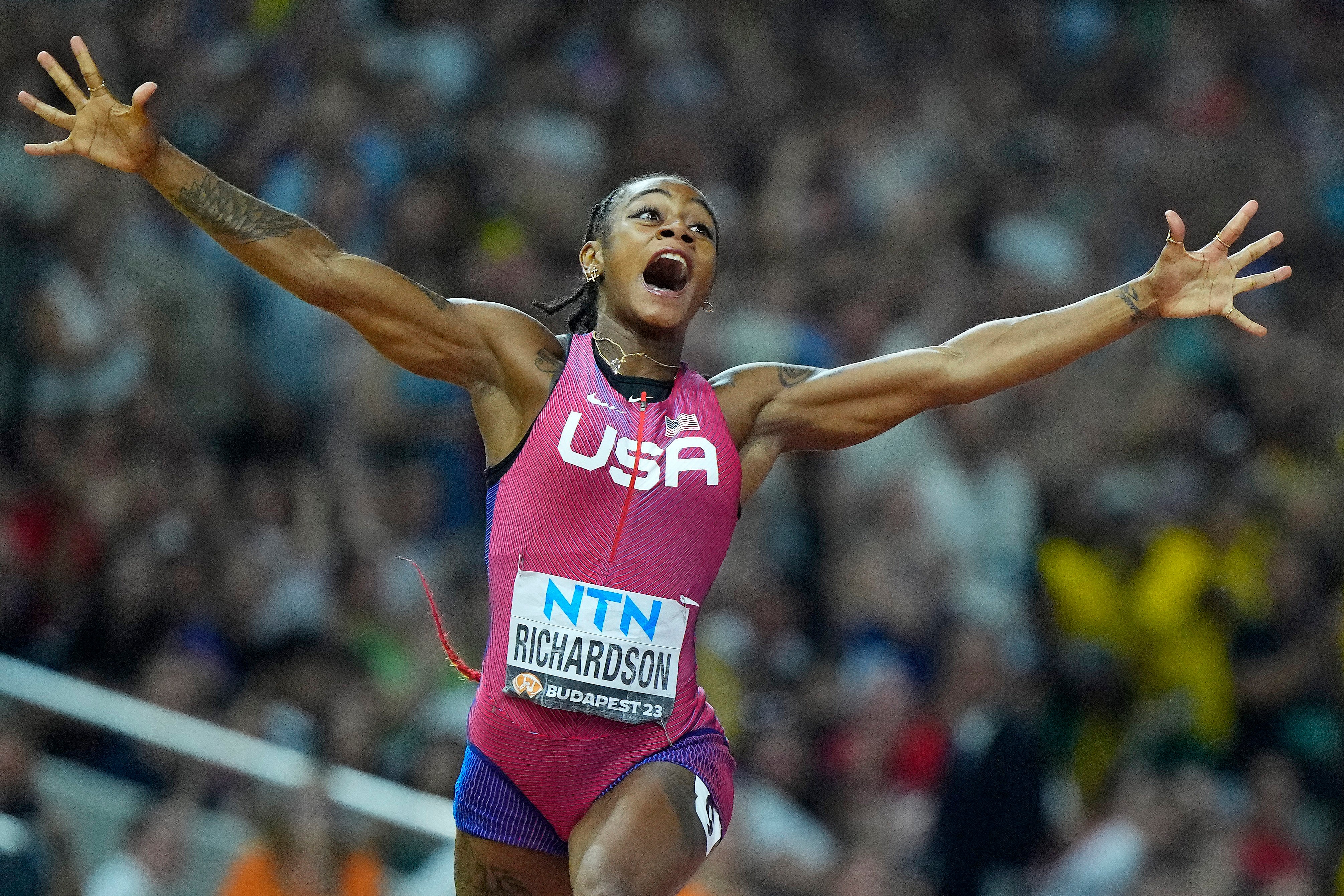 Runner Sha’Carri Richardson celebrates after winning the gold medal