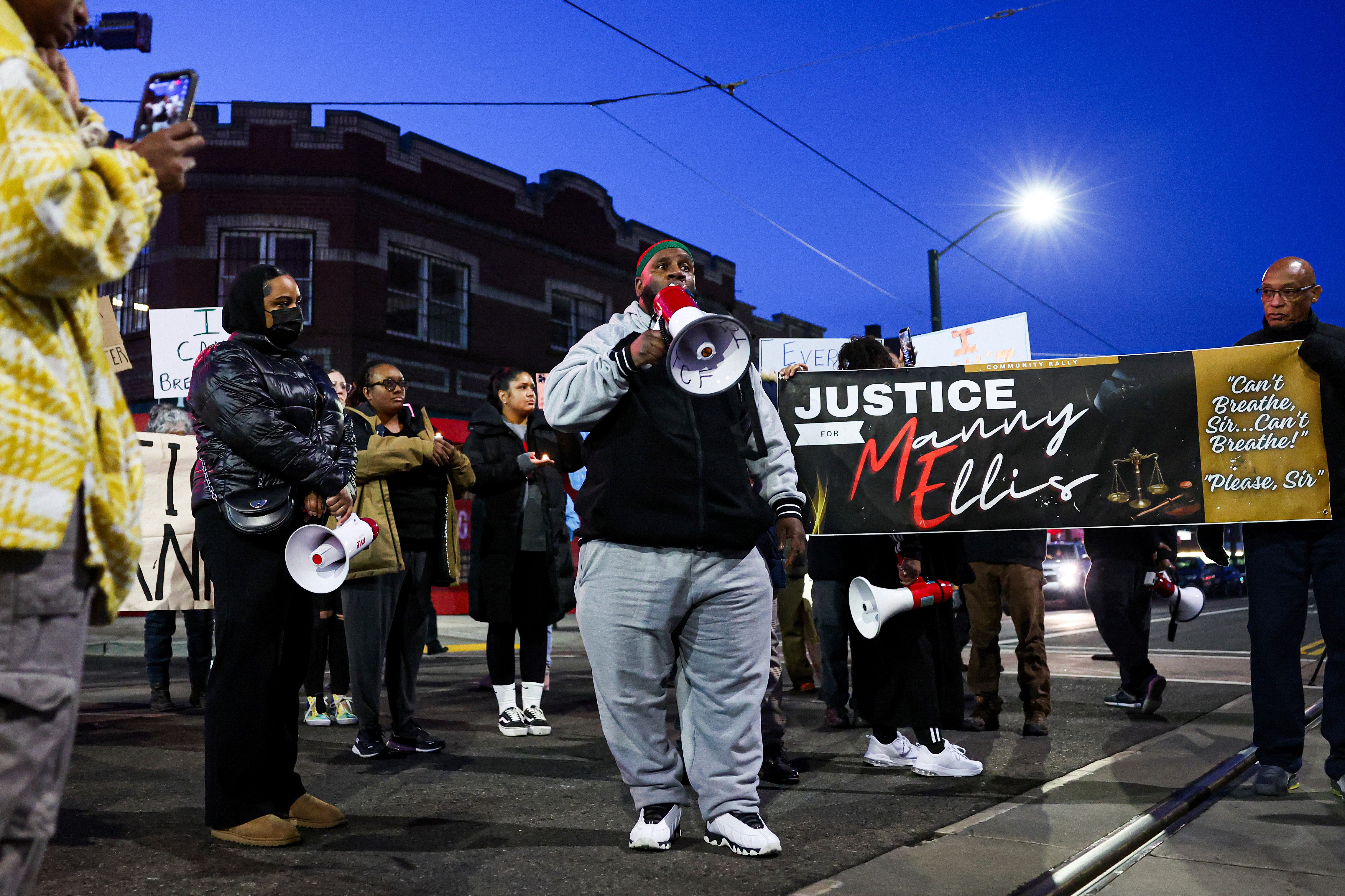 Protestors speak at a rally