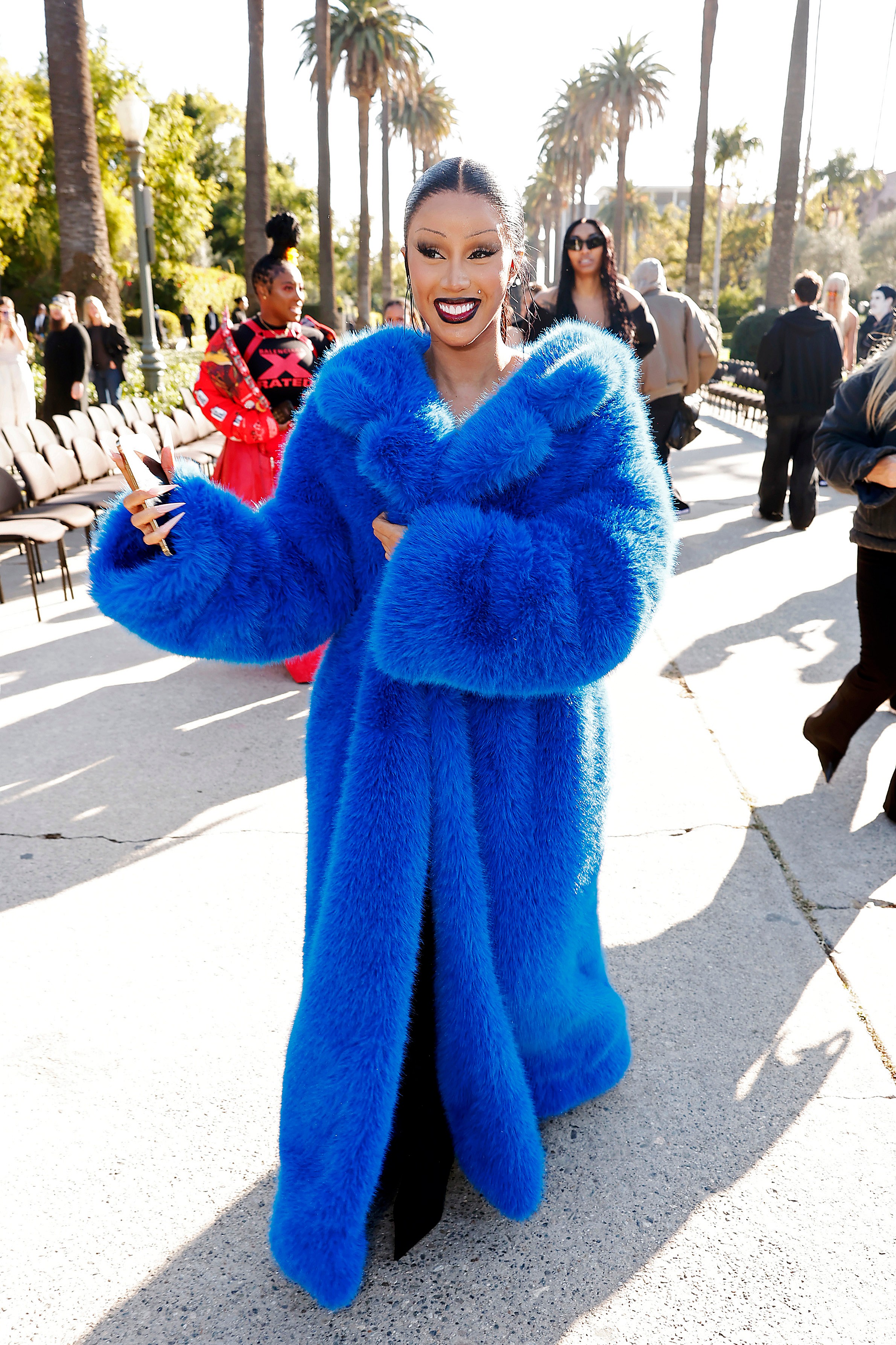 Rapper Cardi B in a full-length blue fur coat