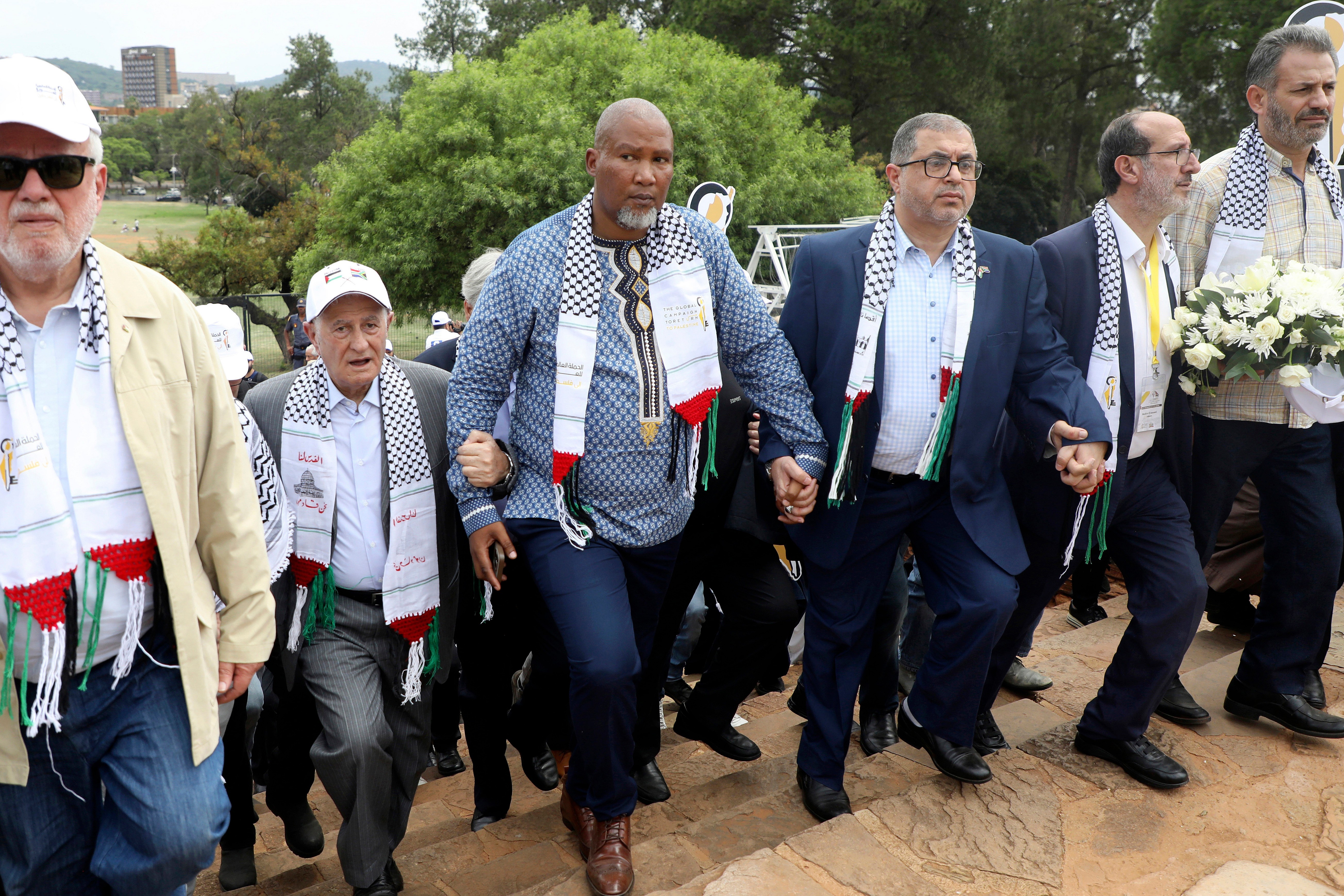 Nelson Mandela’s grandson Mandla Mandela, center, with Hamas official Basem Naim
