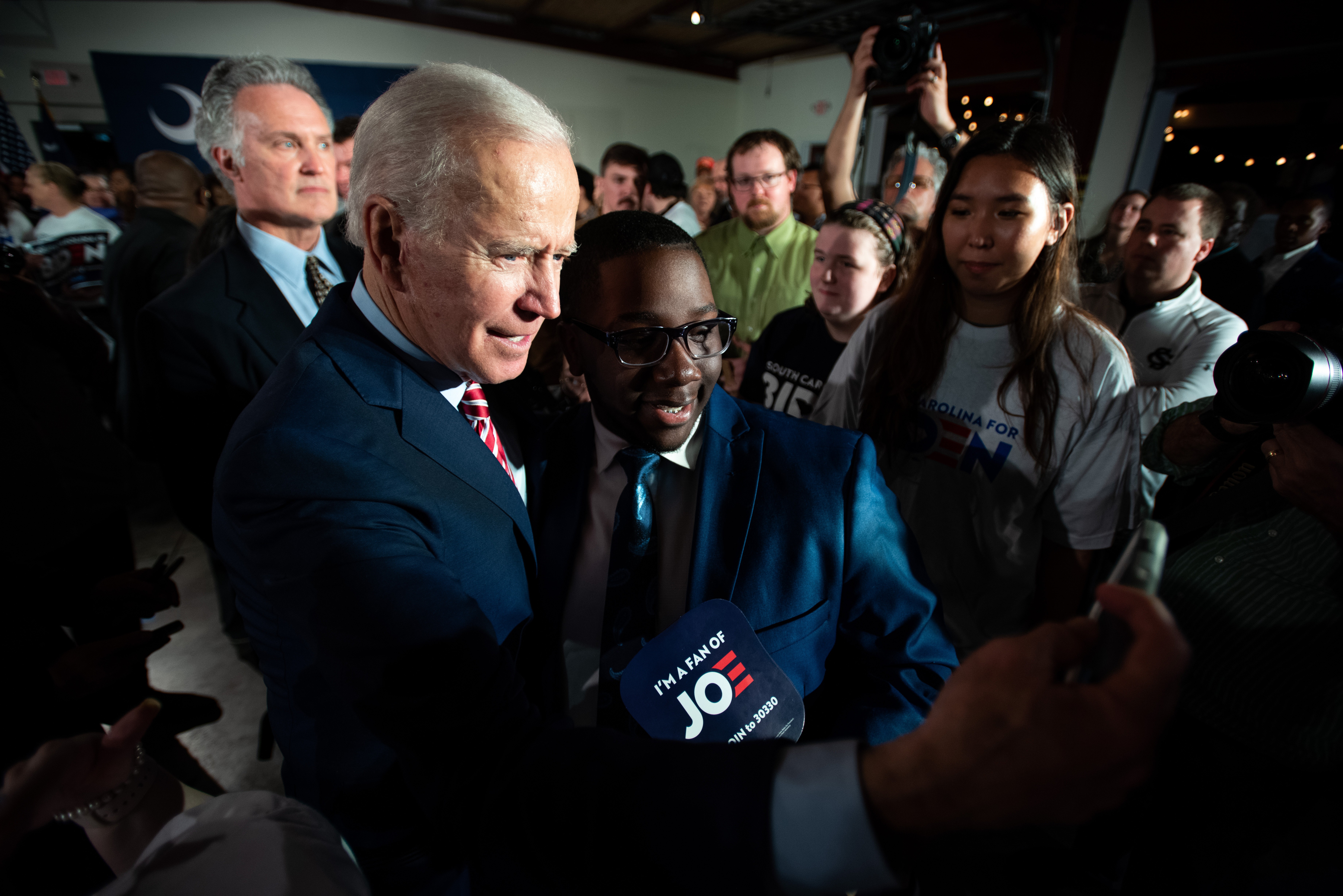 President Joe Biden takes selfies with people