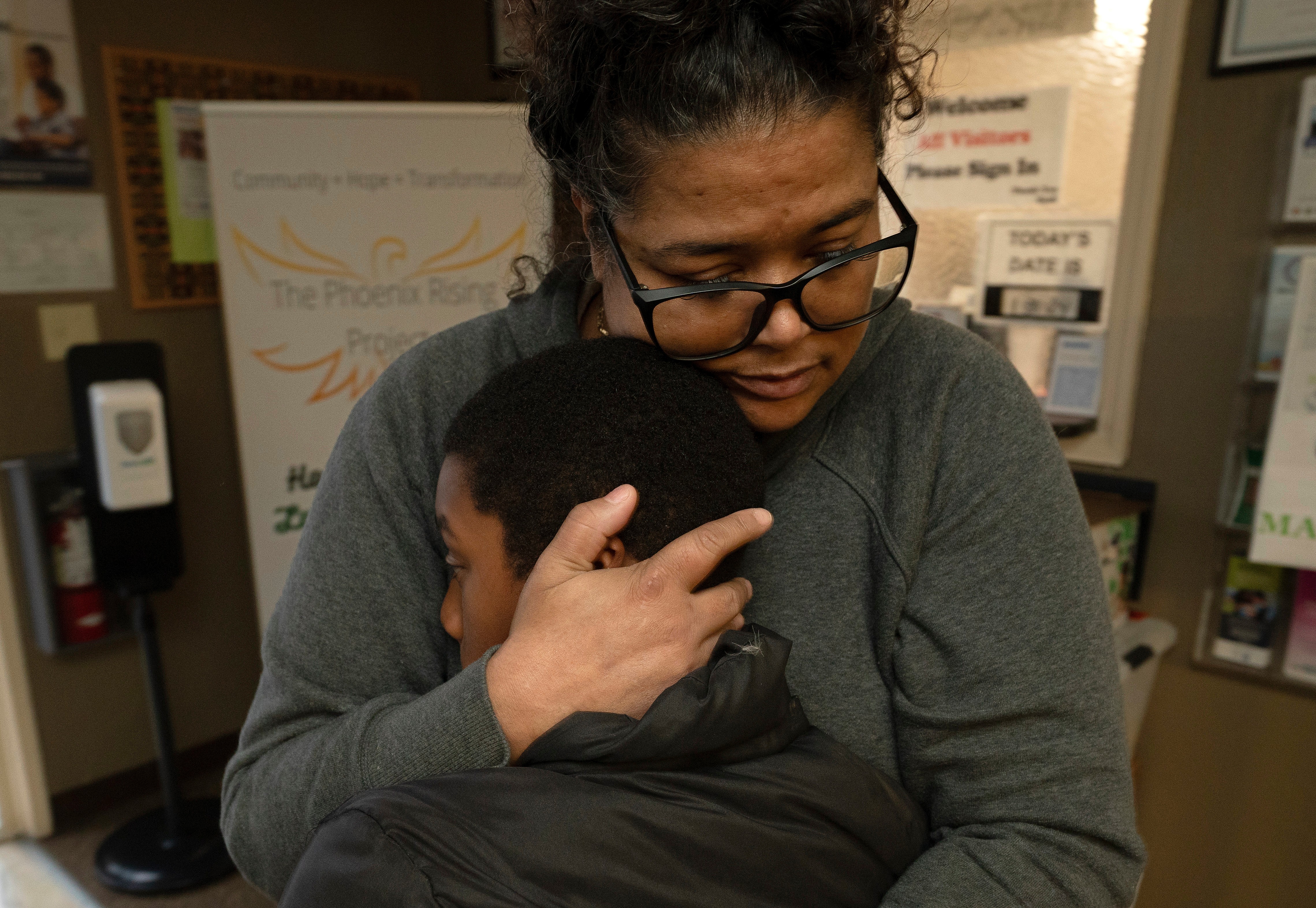 Tiffany McCarter, executive director of the African American Family and Cultural Center, hugs Josiah Banks