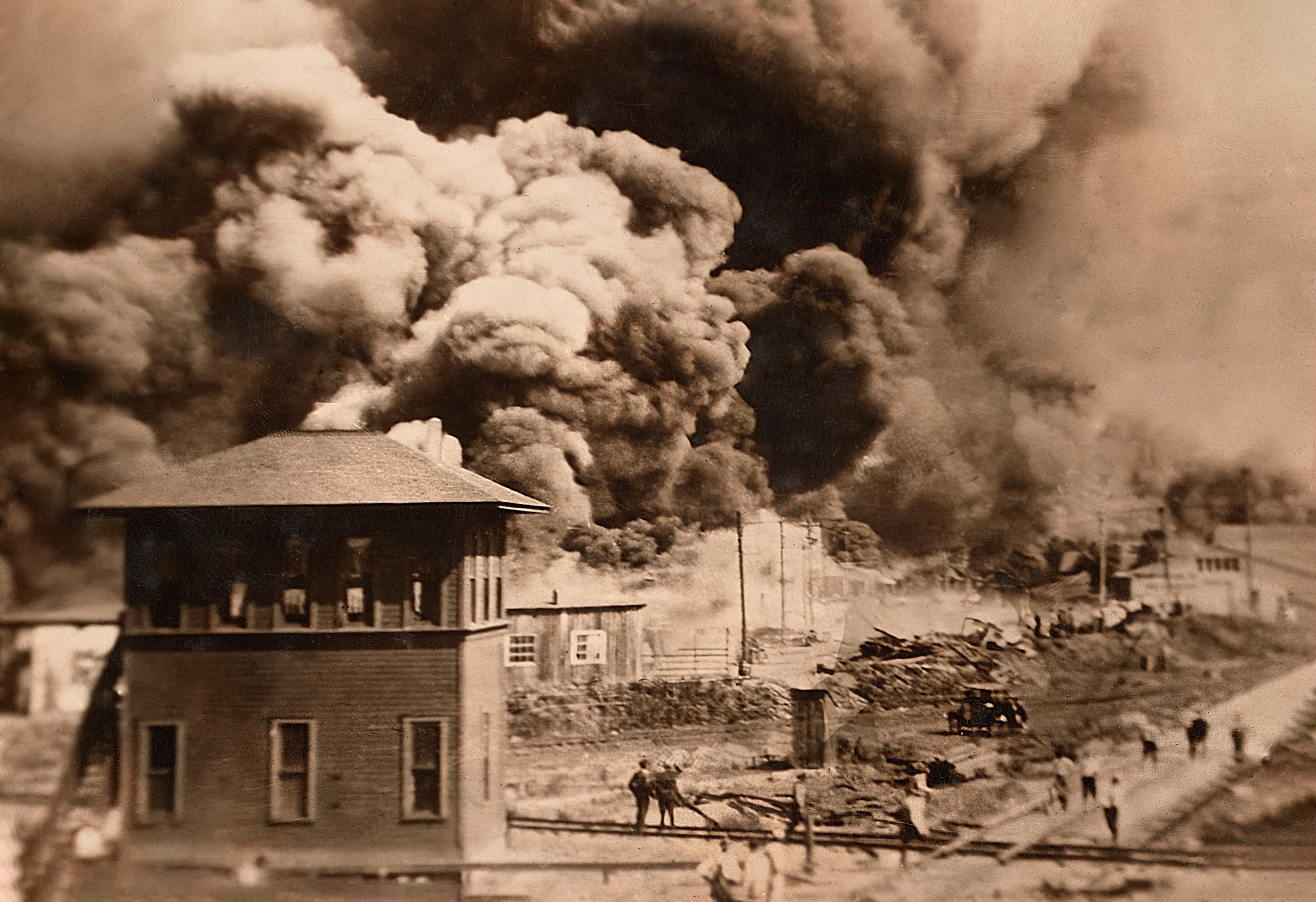 Smoke fills the skies of Tulsa as Black-owned homes and businesses are destroyed in 1921