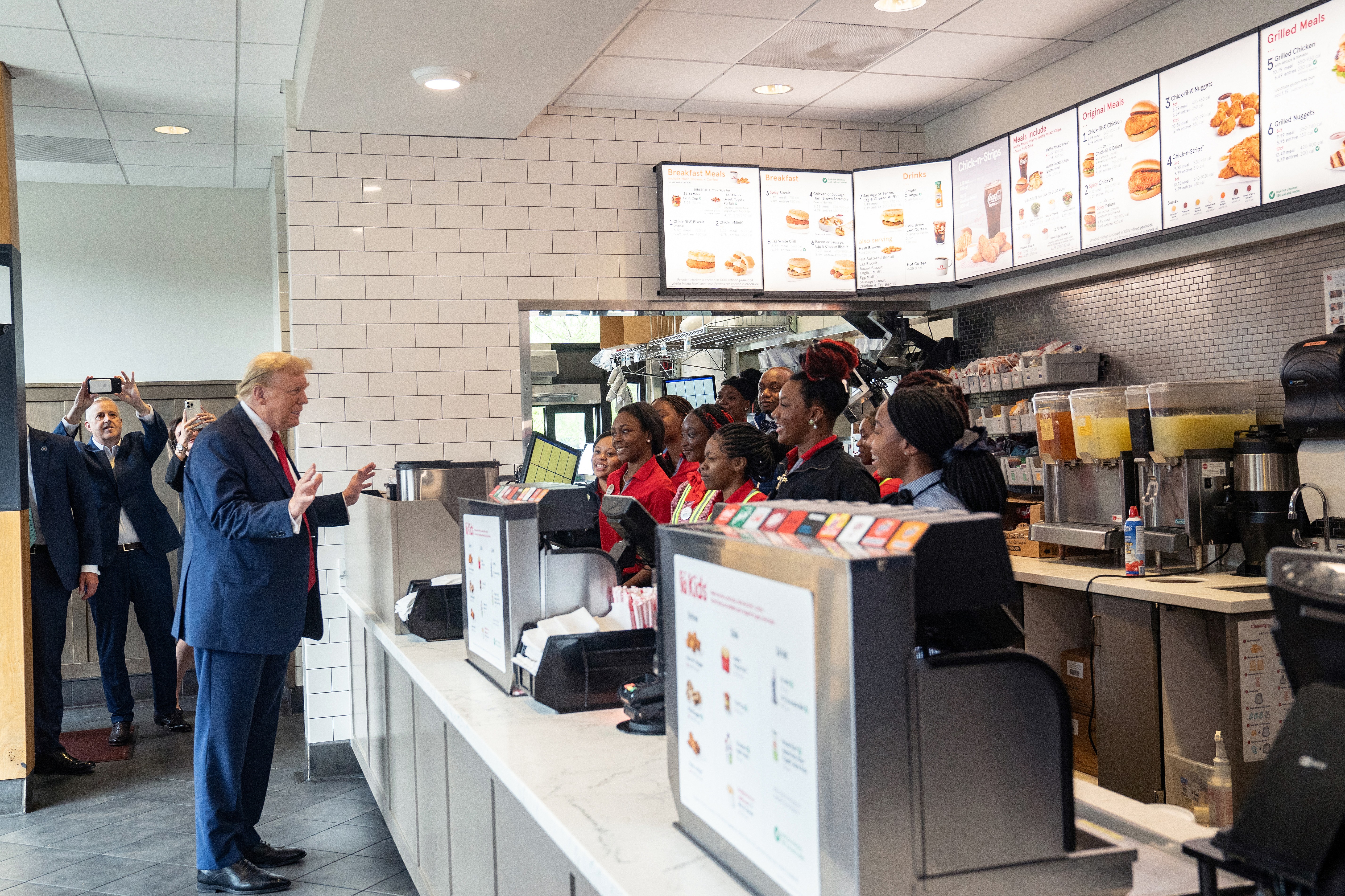 Former President Donald Trump meets employees during a visit to a Chick-fil-A restaurant