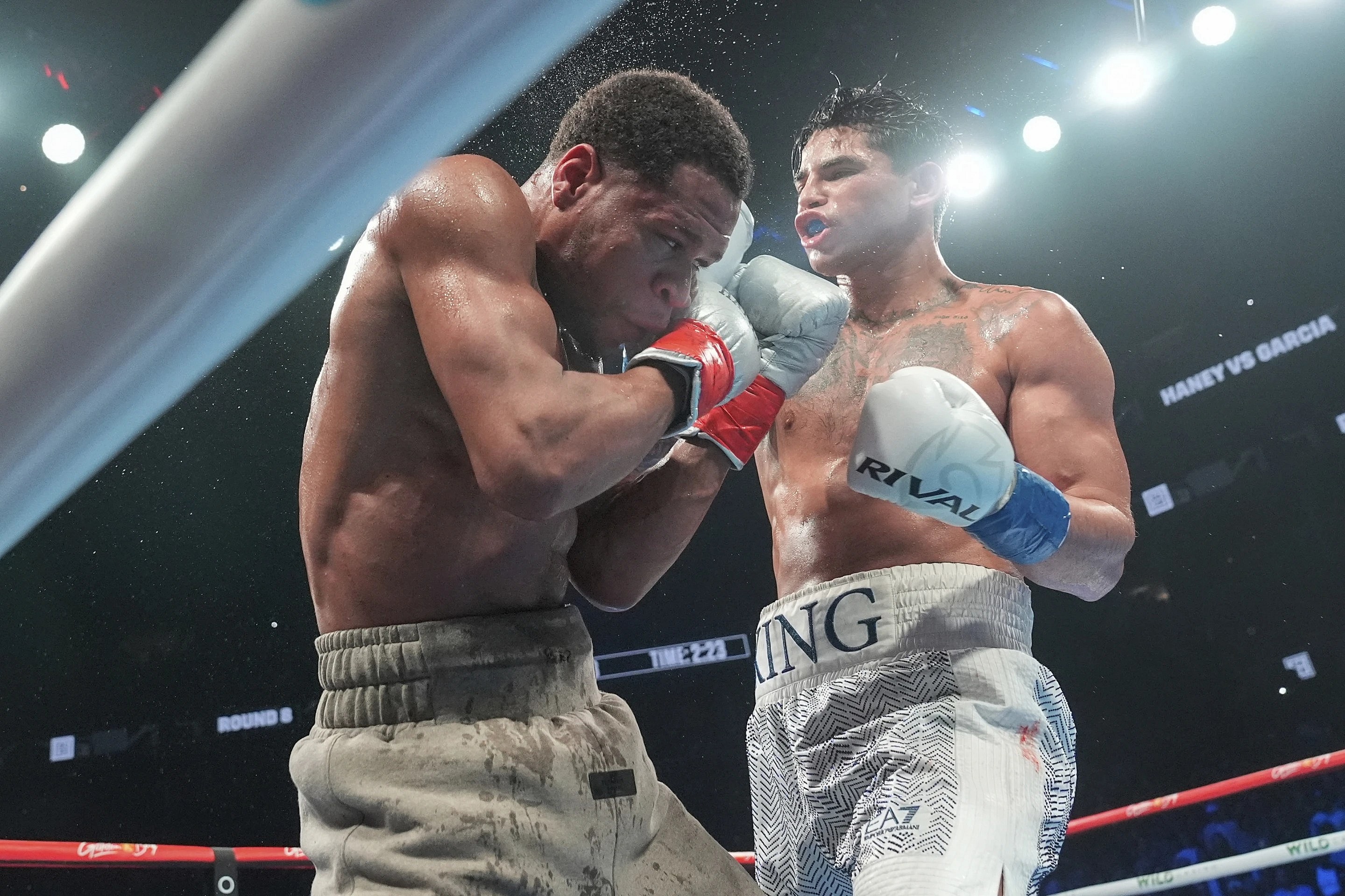 Boxer Ryan Garcia, right, punches Devin Haney