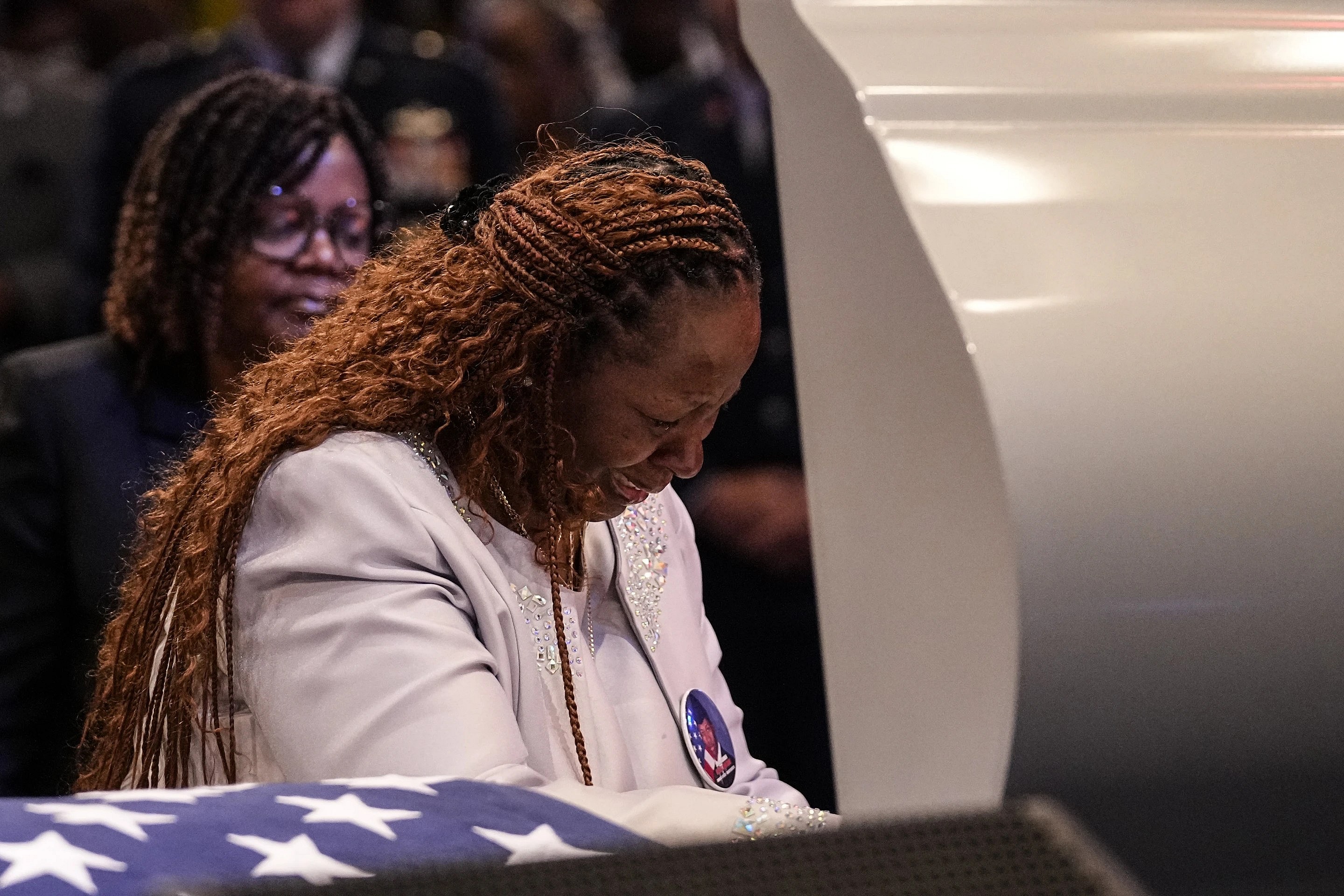 Chantemekki Fortson, mother of slain airman Roger Fortson, stands at his casket