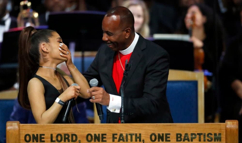 Ariana Grande, left, laughs with Bishop Charles H. Ellis during the funeral service for Aretha Franklin at Greater Grace Temple, Friday, Aug. 31, 2018, in Detroit. Franklin died Aug. 16, 2018 of pancreatic cancer at the age of 76. (AP Photo/Paul Sancya)