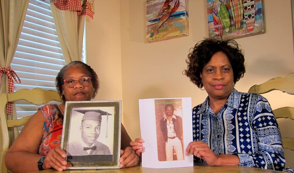 In this Wednesday, April 10, 2019, photo Mylinda Byrd Washington, 66, right, and Louvon Byrd Harris, 61, hold up photographs of their brother James Byrd Jr. in Houston. James Byrd Jr. was the victim of what is considered to be one of the most gruesome hate crime murders in recent Texas history. (AP Photo/Juan Lozano) thegrio.com