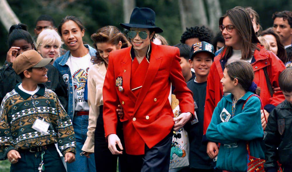 In this April 18, 1995, file photo, pop star Michael Jackson and Lisa Marie Presley, behind him at left, walk with children that were invited guests at his Neverland Ranch home in Santa Ynez, Calif. The co-executor of Jackson's estate says he's confident the late superstar's supporters will be able to protect his legacy and brand in the wake of HBO’s "Leaving Neverland," a documentary detailing allegations of sexual abuse. (AP Photo/Mark J. Terrill, File) thegrio.com