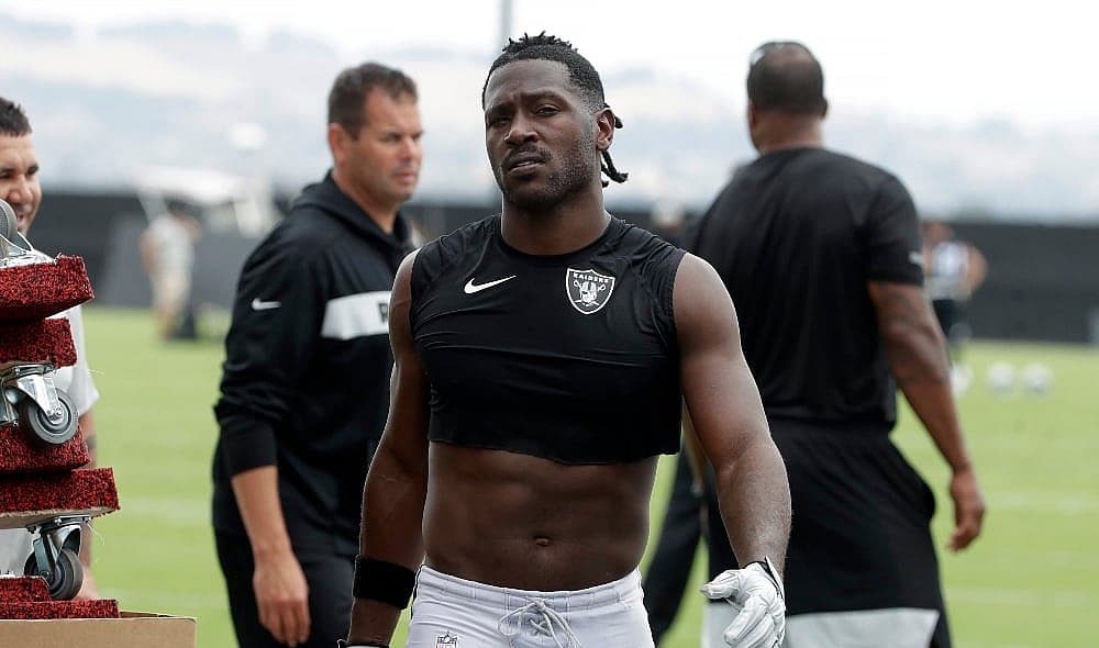 Oakland Raiders' Antonio Brown walks off the field after NFL football practice in Alameda, Calif., Tuesday, Aug. 20, 2019. (AP Photo/Jeff Chiu) thegrio.com