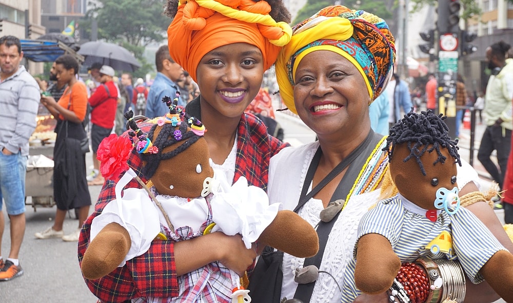 Black Consciousness Day Parade in São Paulo. She was just one-year-old when her grandmother brought her to her first parade. These days, dressed traditionally in headwraps and long skirts, she and her grandmother are seen at the annual event carryin thegrio.com